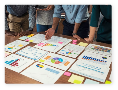 Group of individuals reviewing charts and reports